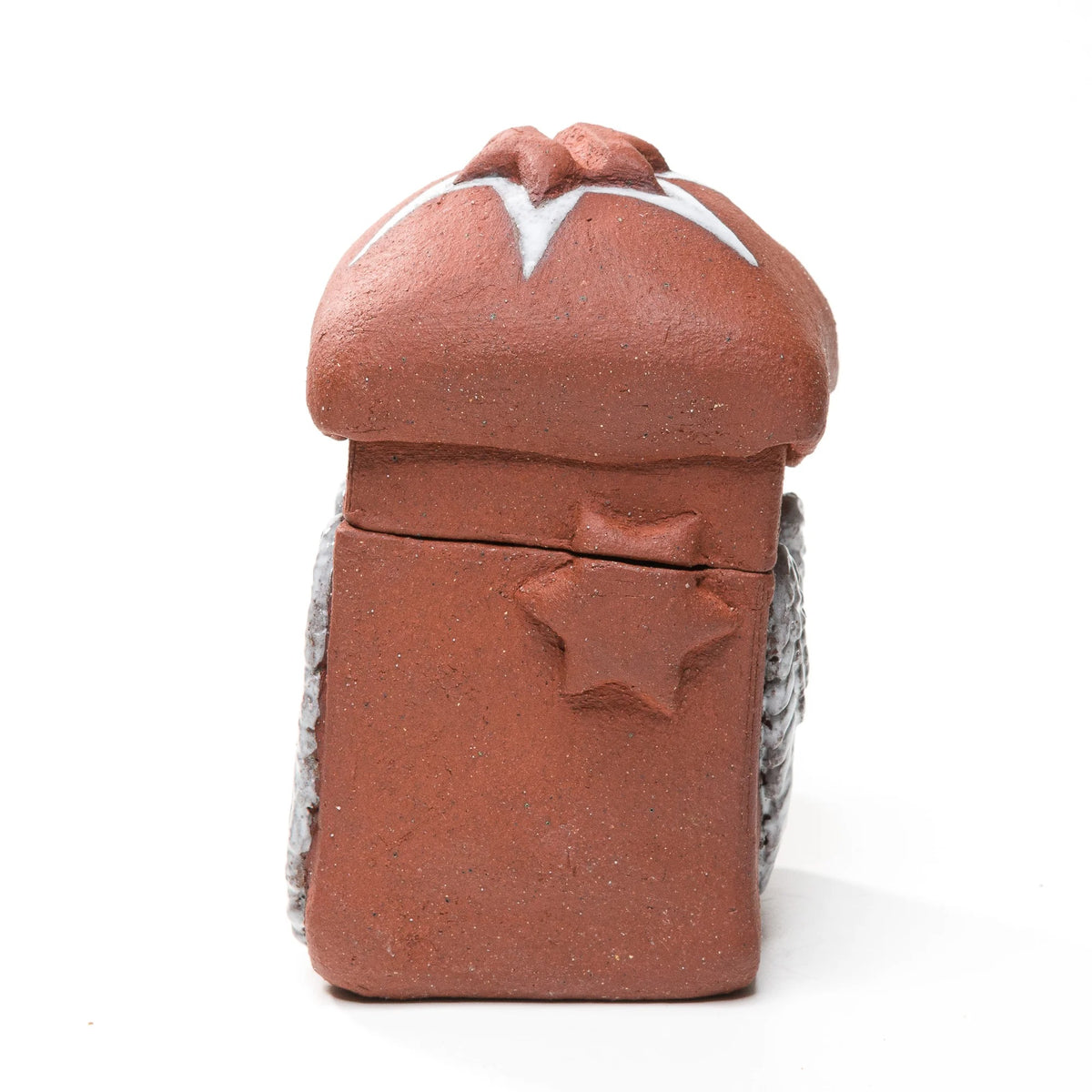 Straight-on view of the stoneware matchbox's raised side star, with white wings visible along both edges