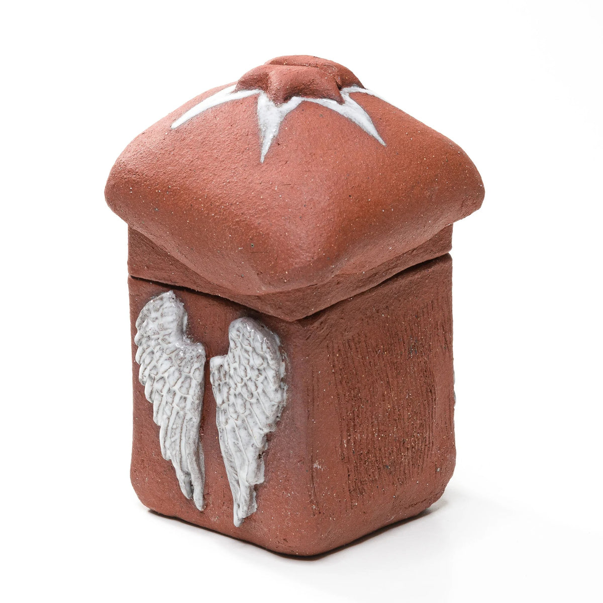 Reddish-brown stoneware matchbox with raised white angel wings and a domed, star-topped lid, viewed at an angle
