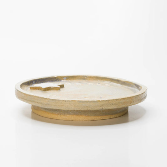 ide view of the Freedom ceramic plate showing its shallow rim, raised Star of David, and circular foot.
