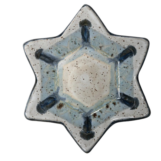 6-pointed Star-shaped ceramic dish with speckled white and pale blue glaze, dark blue accents, and a dark rim.